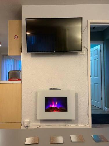 a wall with a flat screen tv on a wall at Gorgeous Gower Chalet in Swansea