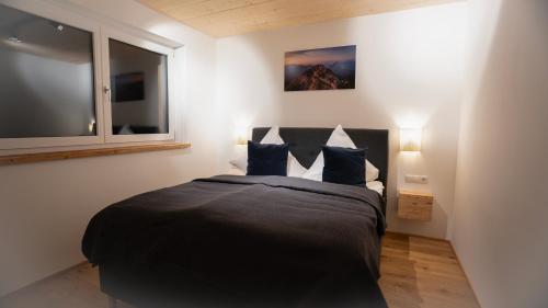 a bedroom with a large bed with blue pillows at Apartment Lola in Seefeld in Tirol