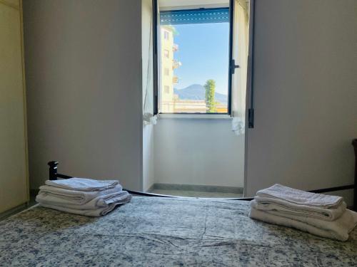 a bedroom with a bed with two towels on it at Cocò Marì in Naples