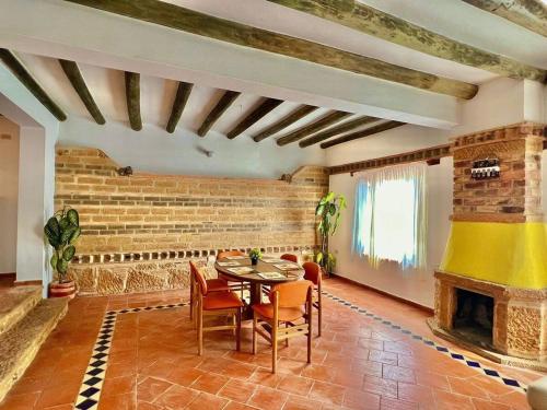 a dining room with a table and a fireplace at Villa charlotte 3 en colombia in Villa de Leyva