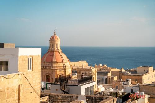 a view of a city with the ocean in the background at Avalon Boutique in Valletta