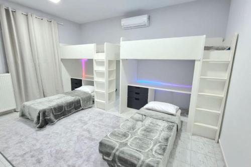 a bedroom with two beds and a bunk bed at Little village Trikala 