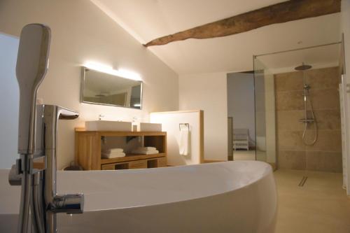 a bathroom with a white tub and a shower at Girauderies Chambres d'Hotes/B+B in Floirac