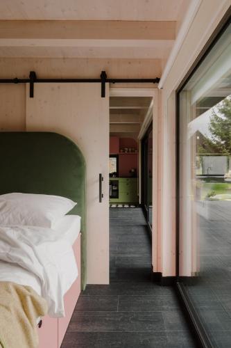 a bedroom with a bed and a door to a balcony at laba in Lasowka