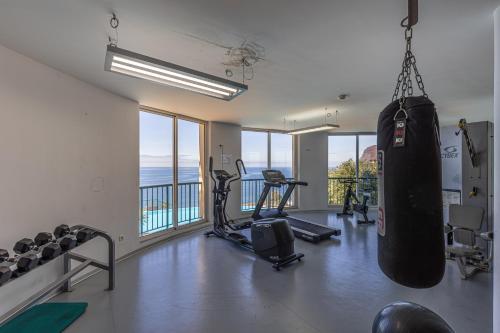 a gym with a punching bag hanging from the ceiling at Ocean view and Infinity pool Apartment in Funchal