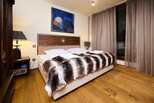 a bedroom with a bed with a black and white comforter at Art Apartments Sievering in Vienna