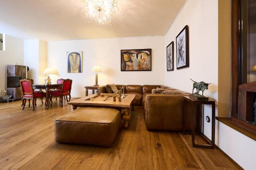 a living room with a couch and a table at Art Apartments Sievering in Vienna