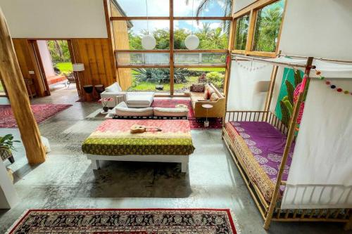a living room with a couch and a bed in it at Jungle Haven Ocean Front Eco Villa On Fruit Farm in Pahoa