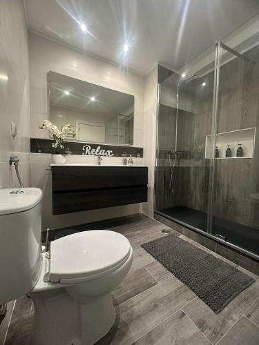 a bathroom with a toilet and a shower at Casa Pescador in Carvoeiro