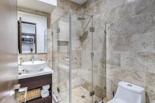 a bathroom with a shower and a toilet and a sink at Fast-Wifi Sunset Studio Tulum with Rooftop and Pool SPA in Tulum