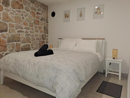 a bedroom with a bed with a teddy bear on it at Villa Si'Seta in Krk