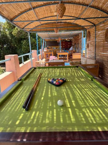 a pool table with cue balls on it in a house at Nubian Holiday House Aswan in Aswan