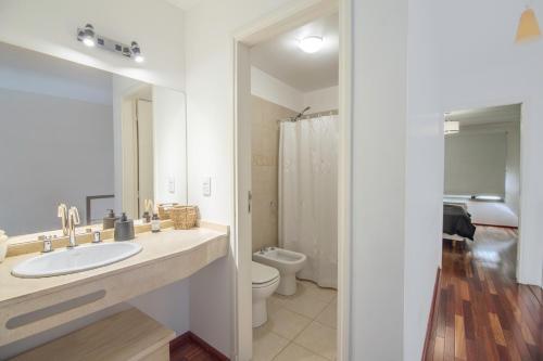 a white bathroom with a sink and a toilet at Great 2-Bedroom Apartment close Playa Bonita QL5 by Apartments Bariloche in San Carlos de Bariloche