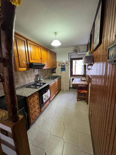 a kitchen with wooden cabinets and a stove top oven at Casa Cardillo in Colere