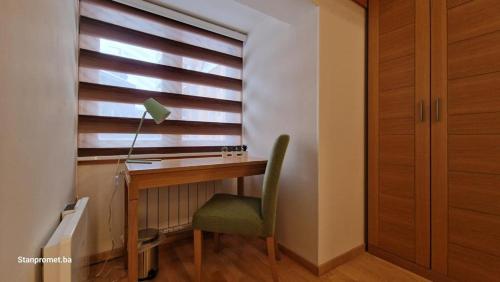 a desk with a chair and a lamp and a window at Apartman 109 LUX - Aparthotel Vucko Jahorina private host in Jahorina