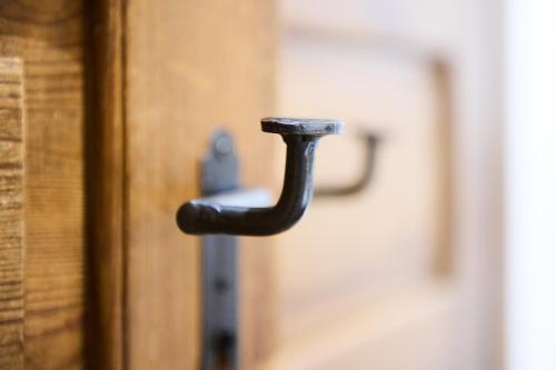 a black door handle on a wooden door at Art Apartments Sievering in Vienna
