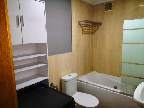 a bathroom with a toilet and a sink and a tub at Apartamento A Cabana II in Porriño