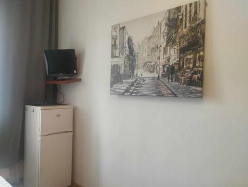 obraz na ścianie z telewizorem na lodówce w obiekcie Apartments Poland Kazimierz w Krakowie