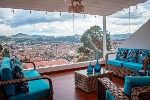 a living room with chairs and a view of a city at Hermosa casa con lujoso rooftop en Cuenca in Cuenca