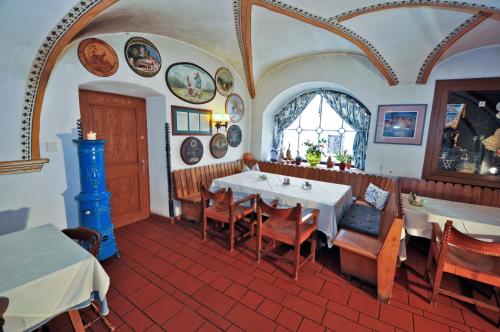 a restaurant with a table and chairs in a room at Gasthof Tell in Paternion
