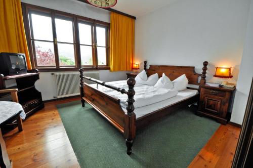 a bedroom with a large bed with white pillows at Gasthof Tell in Paternion