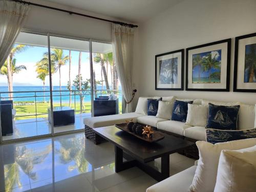 a living room with a couch and a table at SEAWINDS CABARETE Front beach Condo in Cabarete