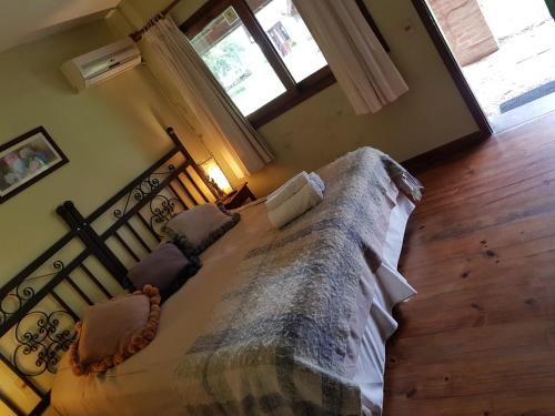 a bedroom with a large bed with a large window at Finca Piedra in Mal Abrigo