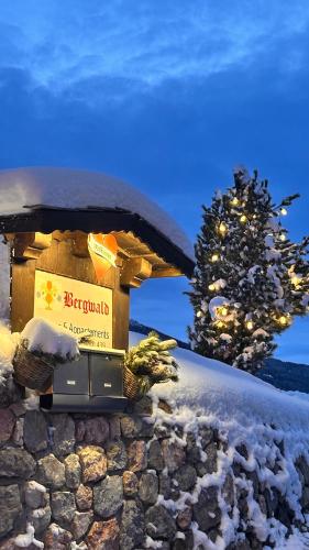 a box on a wall with a christmas tree in the background at Bergwald Appartements Alpbach in Alpbach