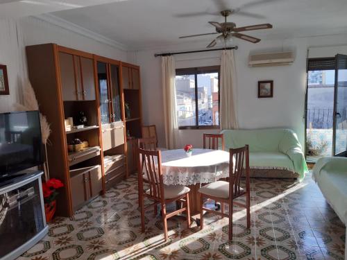 a living room with a table and chairs and a tv at Apartamento Vernissa in Gandía