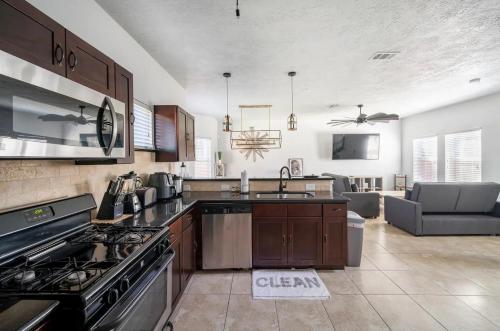 a kitchen with a stove top oven next to a living room at *Heart of Houston* Pet friendly/14ppl/4br/2.5b in Houston