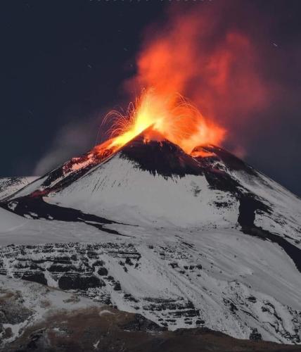 a mountain with a fire on top of it at Petite Maison dell'Etna in Milo