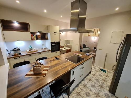 - une cuisine avec un comptoir en bois dans l'établissement Studio chaleureux & moderne, région bruxelloise, à Asse