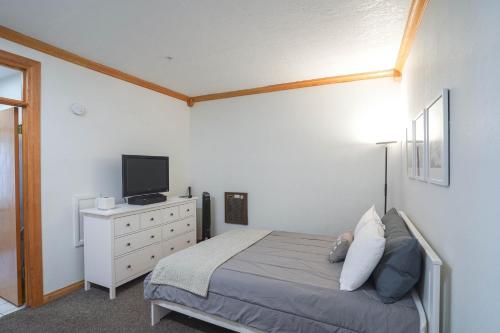 a bedroom with a bed with a television and a dresser at Cozy Brian Head Condo Walk to Navajo Express Lift in Brian Head
