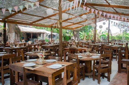 an empty restaurant with wooden tables and chairs at Finca El Milagro in Salta