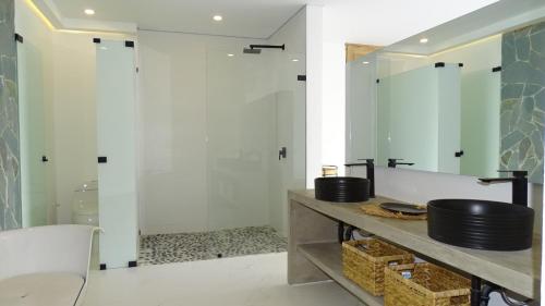 a bathroom with a shower and a sink at Selva Serena in Anapoima