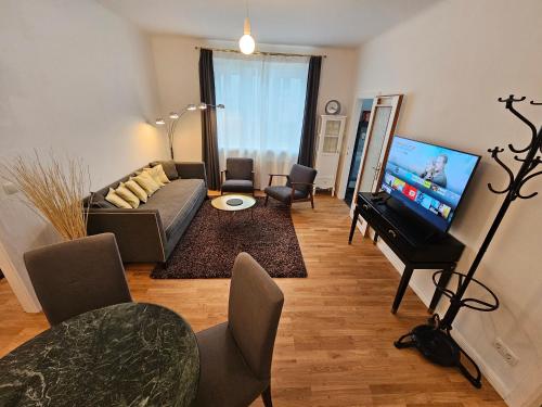 a living room with a couch and a flat screen tv at Yuki's Place - Central Design Apartment - Vienna Trade Fair - WU Campus - Downtown - Subway in Vienna