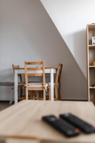 a table and chairs in a room with a staircase at Apartmani Jezero Divčibare in Divčibare