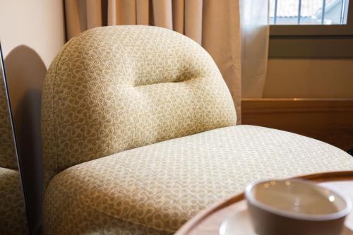 a chair with a bowl sitting on a table at Serra Boutique Hôtel in Agen