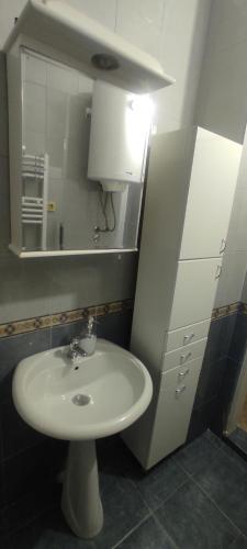 a bathroom with a white sink and a mirror at Apartmani Kačara in Sremski Karlovci