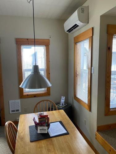 a kitchen with a wooden table with aendant light at BOATYARRD Inn # 9 in Langley