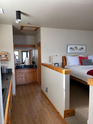a bedroom with a bed and a kitchen with a sink at BOATYARRD Inn # 9 in Langley