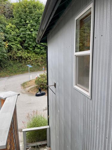 a gray building with a window next to a driveway at BOATYARRD Inn # 9 in Langley