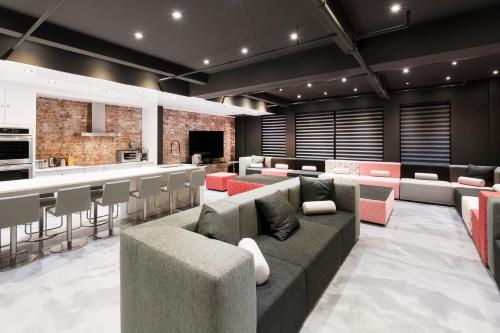 a lobby with couches and a bar and a kitchen at The Holland Hotel by Simplissimmo in Montréal