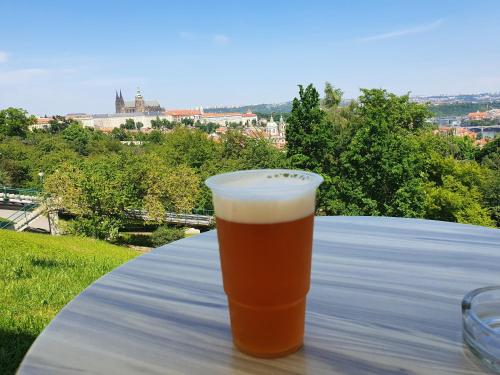 a glass of beer sitting on a table at Cozy Apt Near Prague Castle in Prague