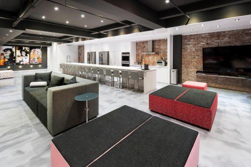 a living room with a couch and a bar at The Holland Hotel by Simplissimmo in Montréal