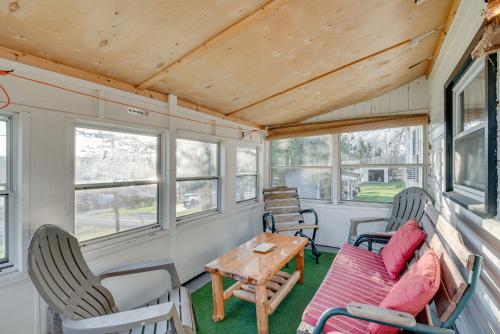 a living room of a tiny house with a table and chairs at Cozy Pennsylvania Home with Fire Pit and Dock Access! in Carbondale