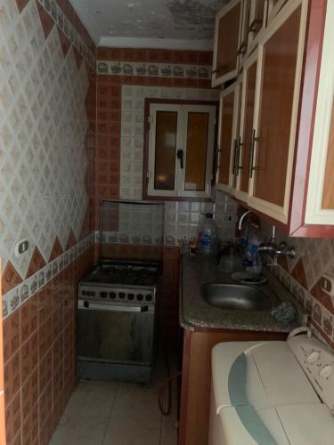 a small kitchen with a stove and a sink at Paradise Beach Alexandria Sea View - Free Wi-Fi - Alex in Alexandria