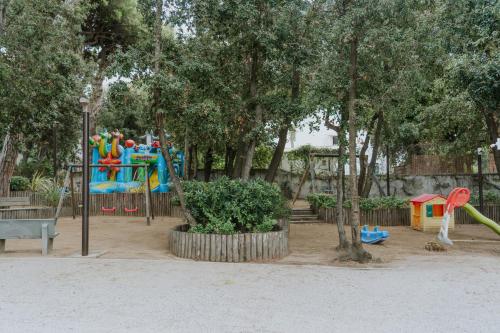 a park with a playground with a slide at Il Delfinetto in San Vincenzo