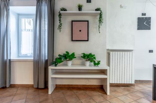 a white console table with plants in a room at LaStefyHome in Civezzano