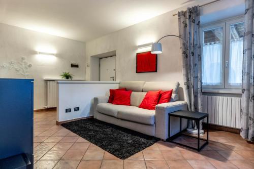 a living room with a couch and red pillows at LaStefyHome in Civezzano